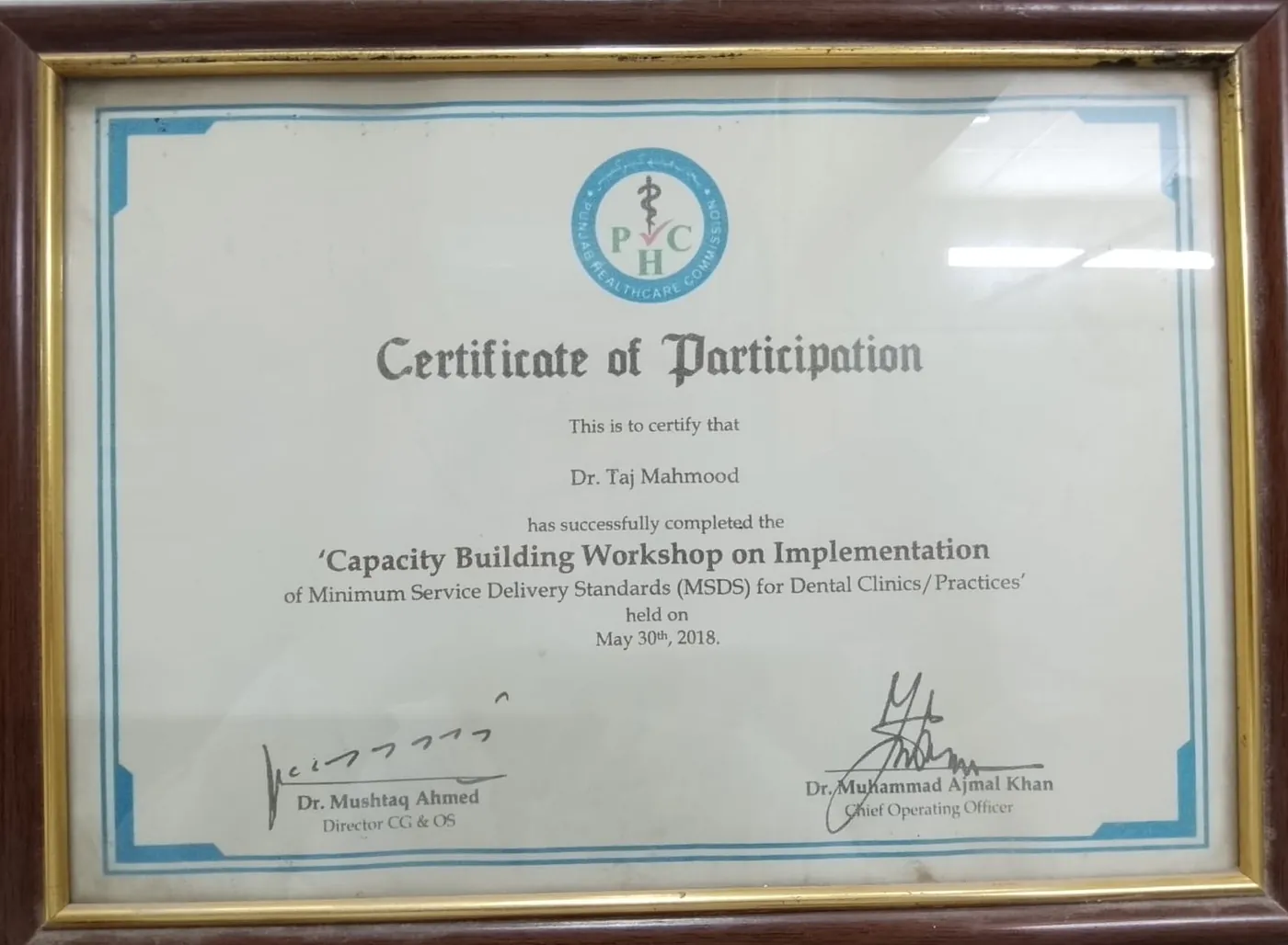 Punjab Healthcare Commission certificate of participation for Dr. Taj Mahmood, dental clinic service standards workshop, 2018